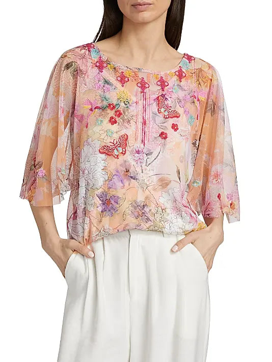 Woman wearing a floral blouse with a white background