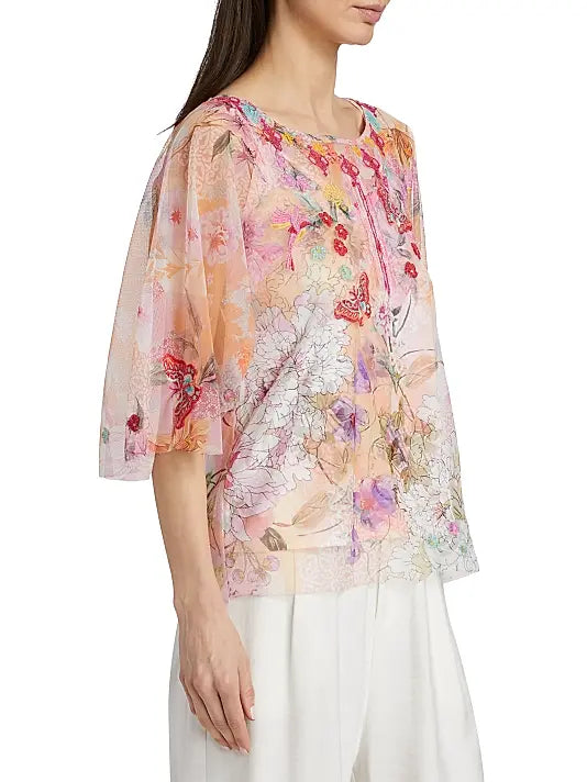 Woman wearing a floral blouse with a white background