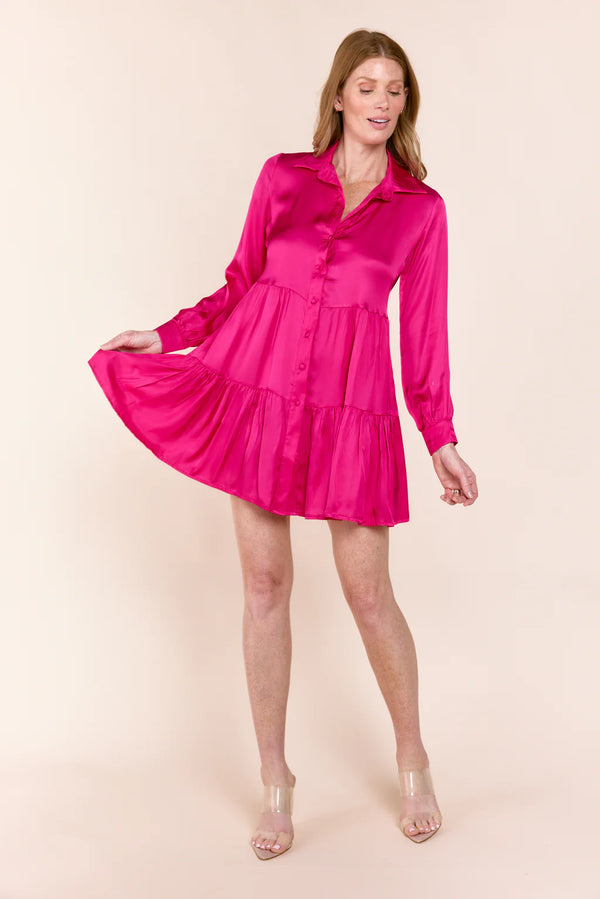 Woman wearing pink silk tiered button down dress