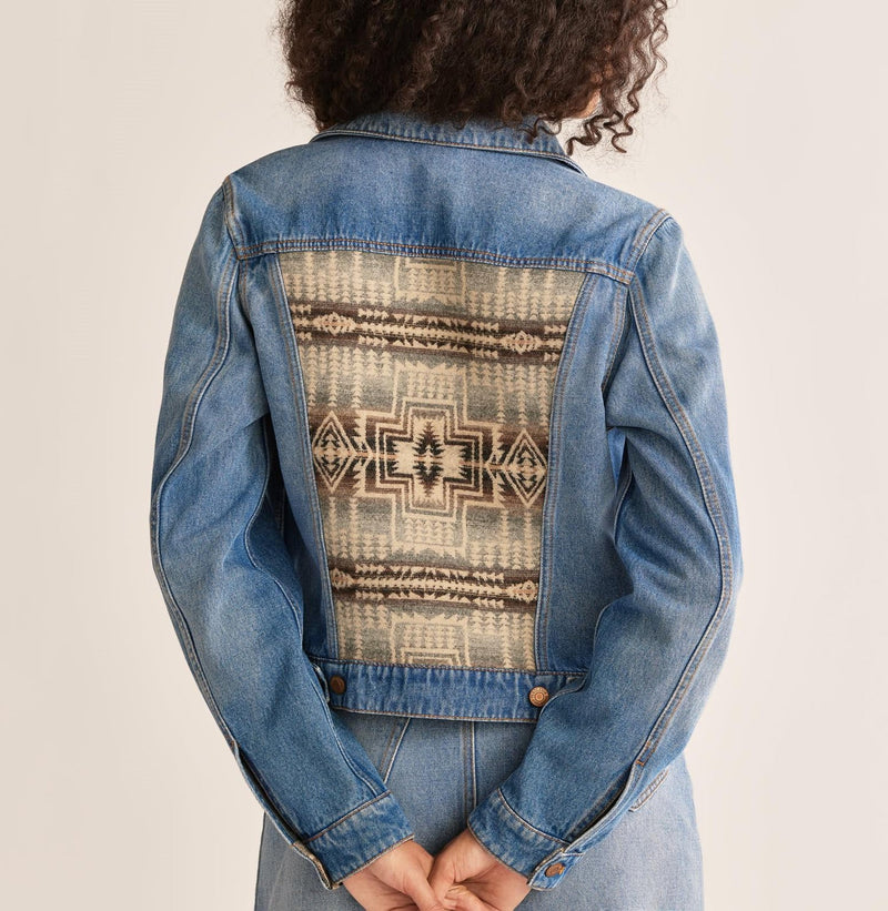 Woman wearing denim jacket with wool Aztec design on the back and shoulders