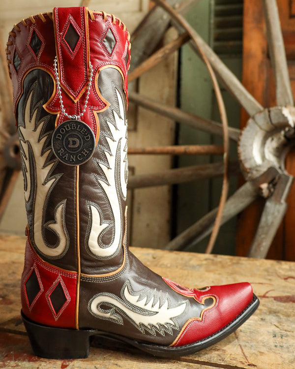 Red and brown cowboy boot with intricate designs on a wooden surface.