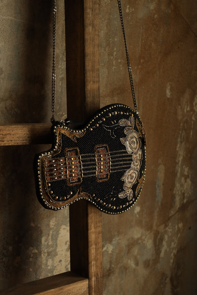 Hand beaded black electric guitar crossbody purse with gold accents with embroidered flowers on the base