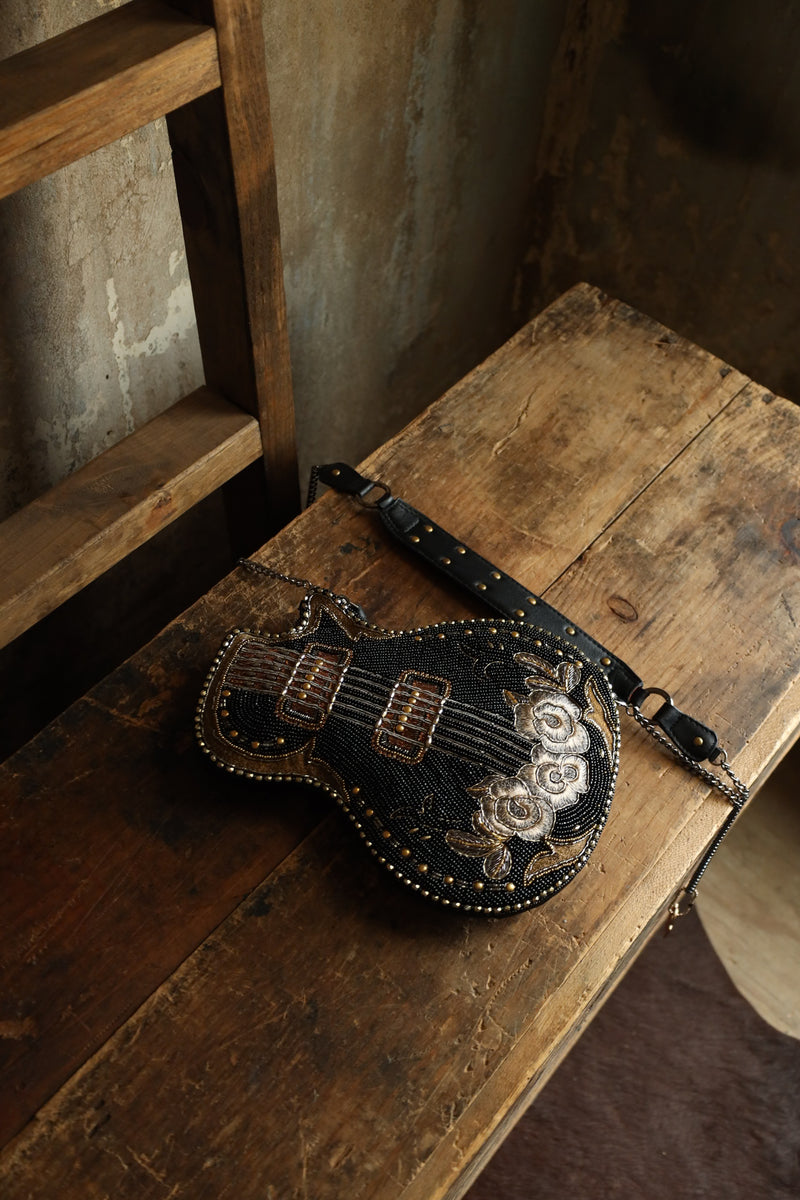 Hand beaded black electric guitar crossbody purse with gold accents with embroidered flowers on the base