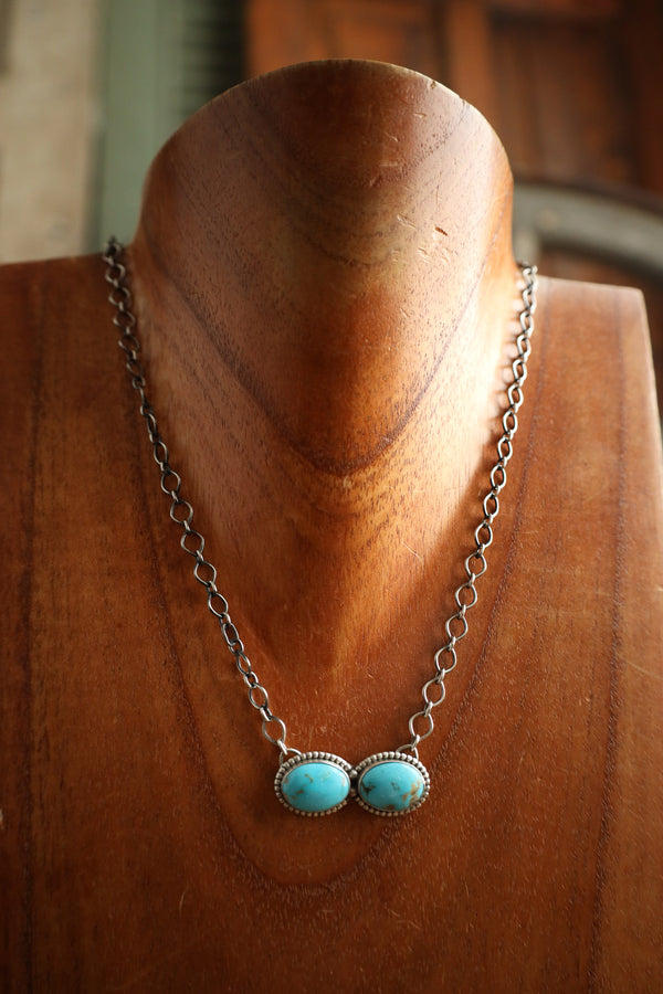 Necklace with turquoise stones on a wooden mannequin