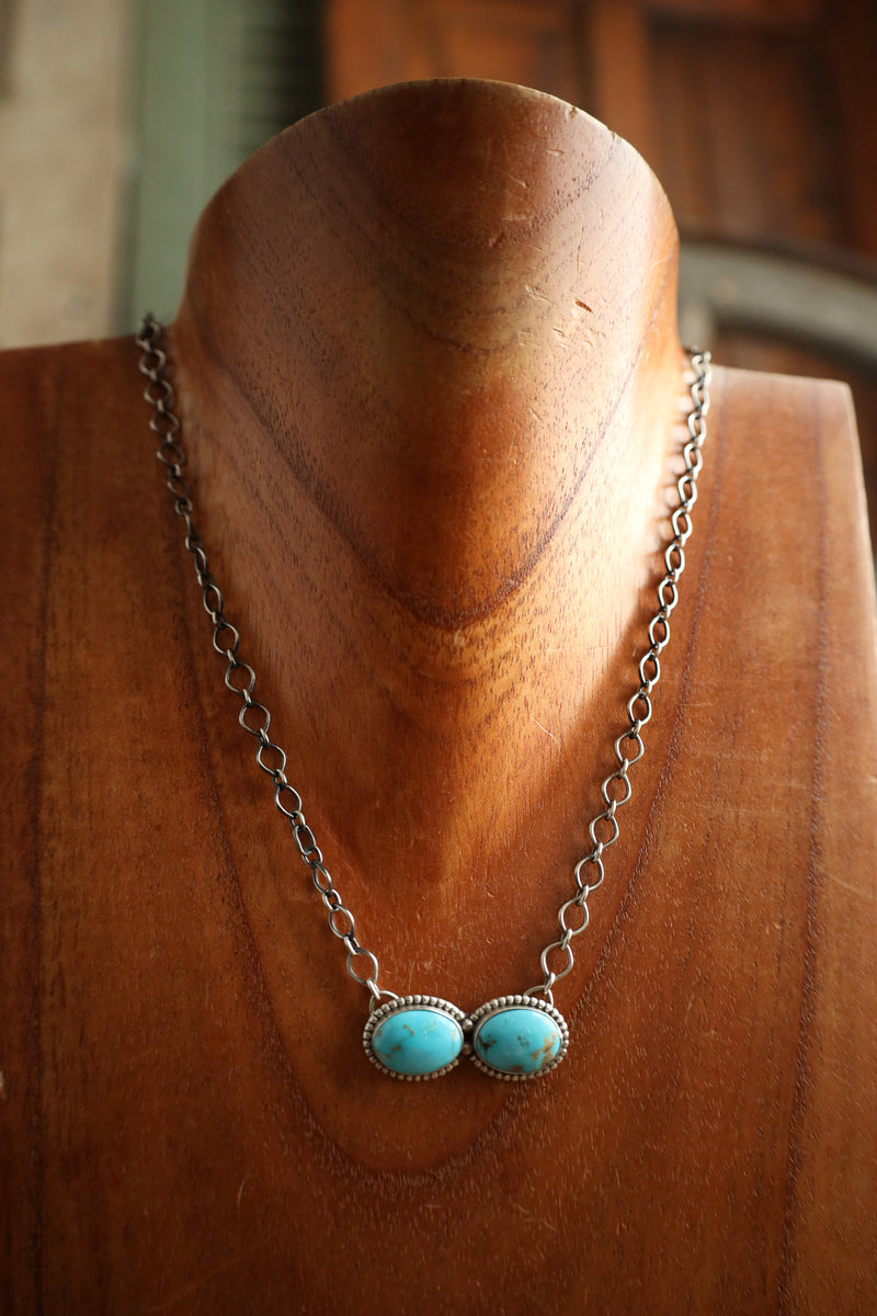 Necklace with turquoise stones on a wooden mannequin