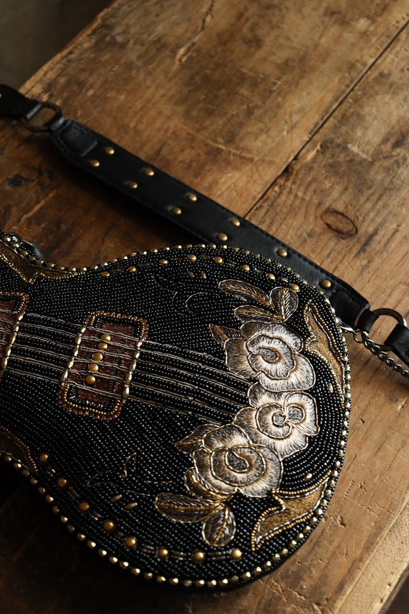 Hand beaded black electric guitar crossbody purse with gold accents with embroidered flowers on the base