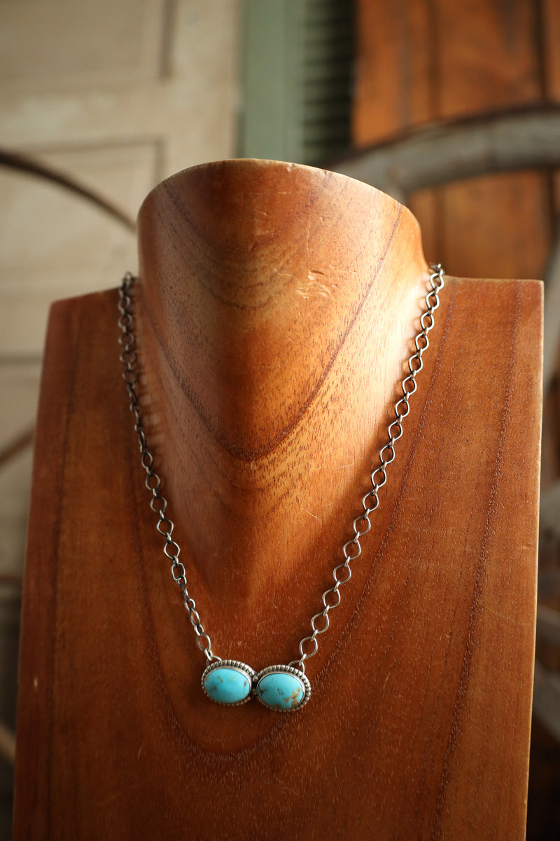 Necklace with turquoise beads on a wooden stand
