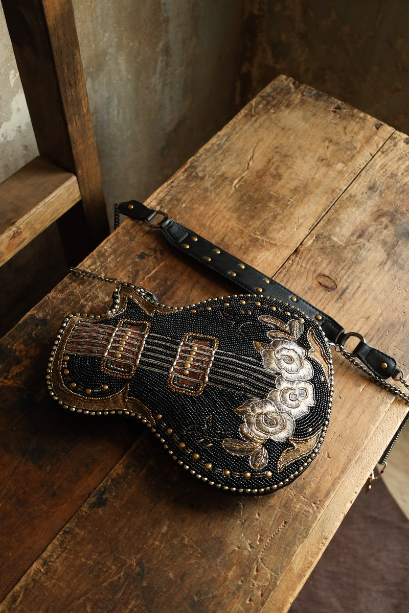 Hand beaded black electric guitar crossbody purse with gold accents with embroidered flowers on the base