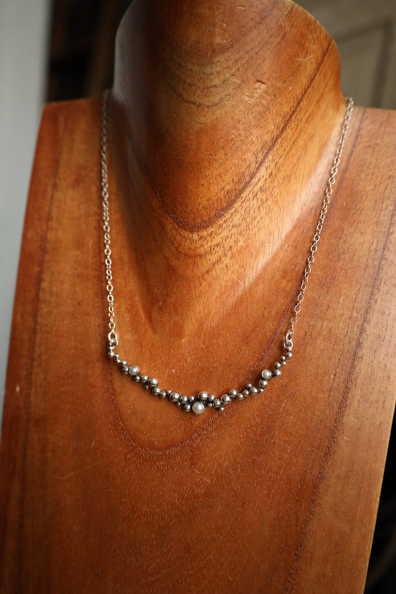 Necklace on a wooden mannequin