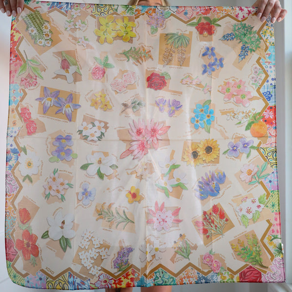 Colorful floral patterned fabric held by hands