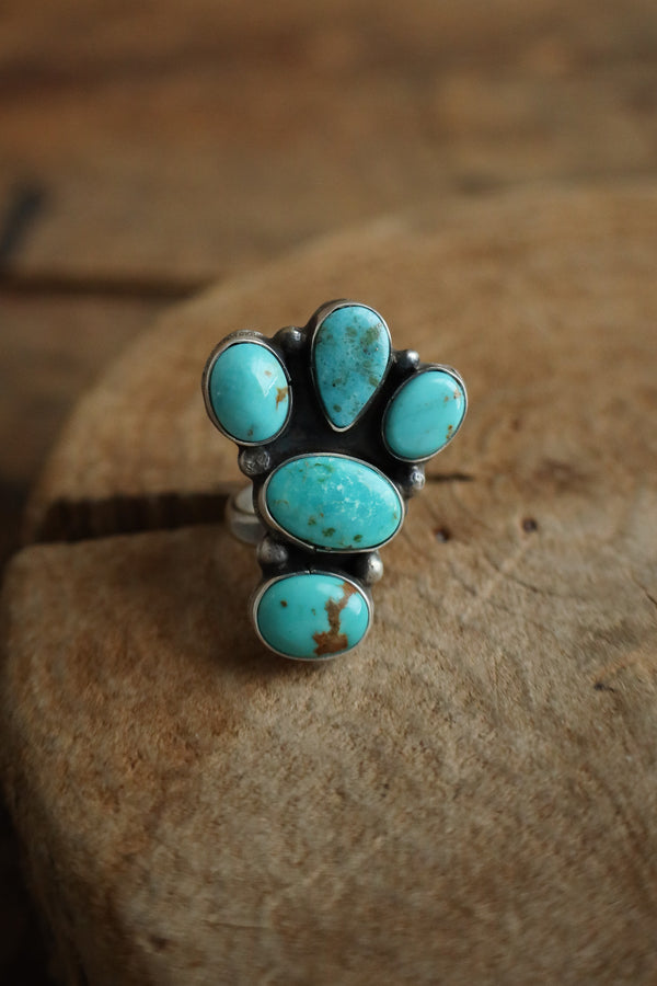 Turquoise stone ring on a wooden surface