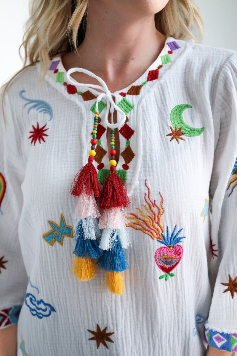 Colorful embroidered blouse with tassels and intricate patterns