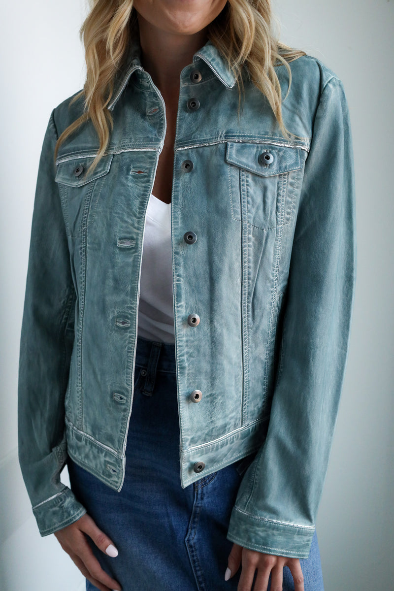 Light blue denim jacket worn by a person on a plain background