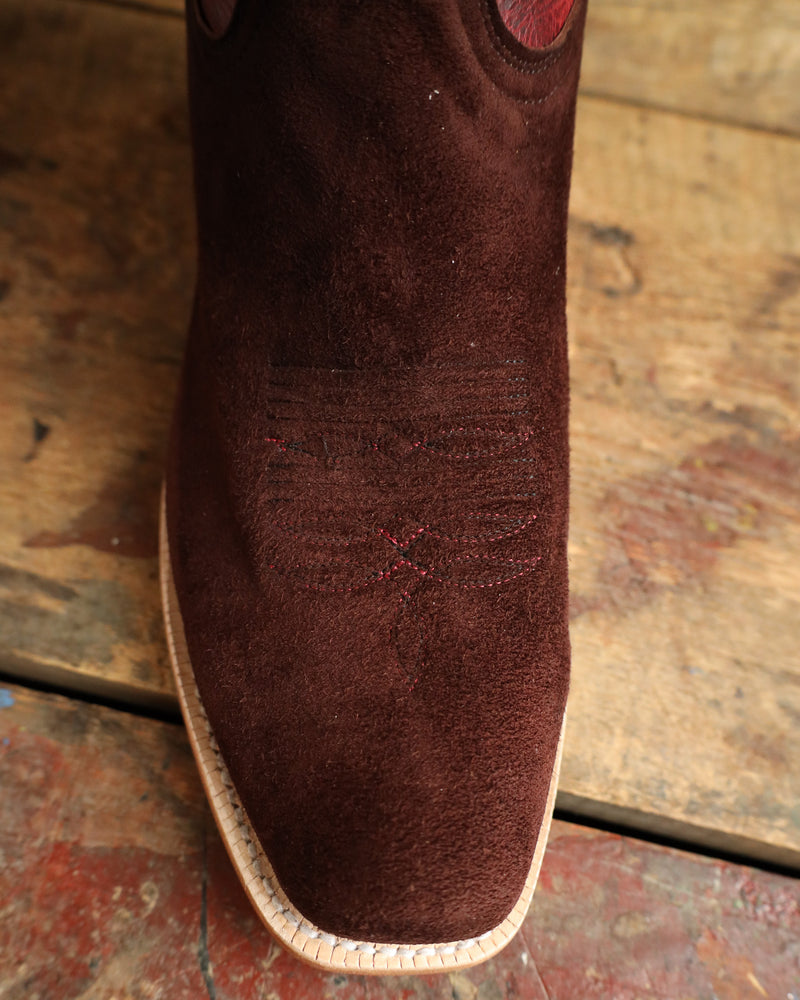 Brown boot sole with embossed pattern on a wooden surface
