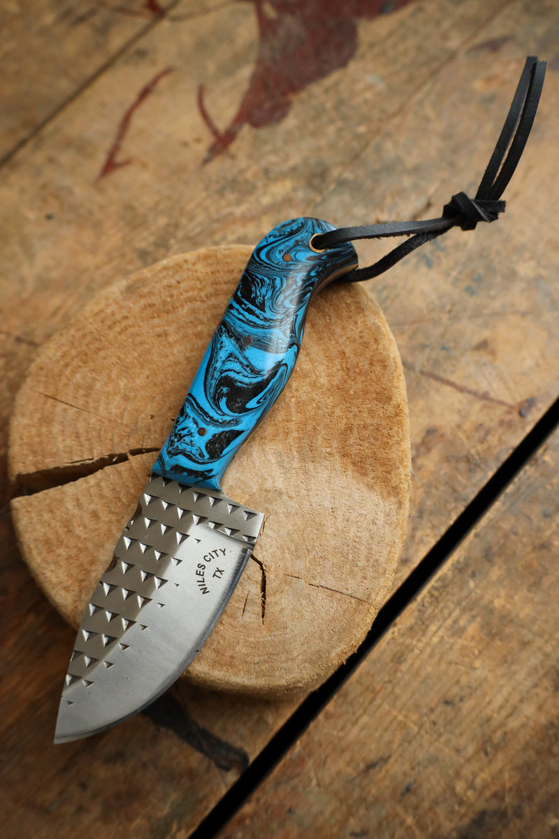 Knife with a blue handle on a wooden surface