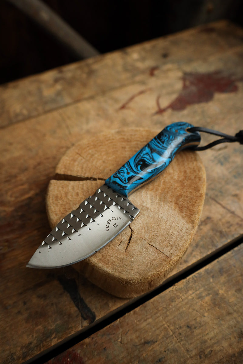 Knife with a blue handle on a wooden surface