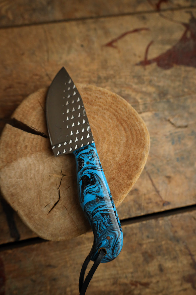 Knife with a blue handle on a wooden surface