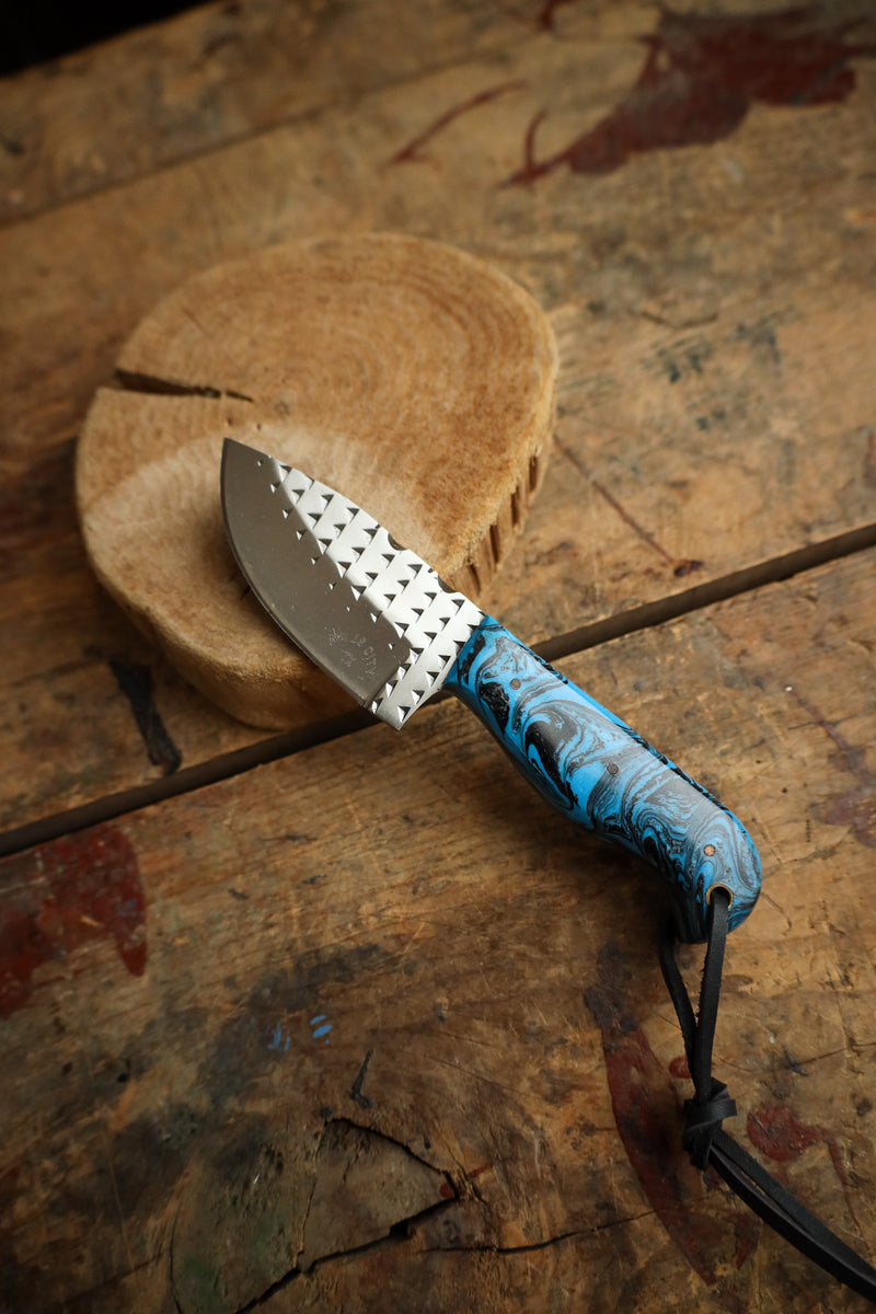Knife with a blue handle on a wooden surface
