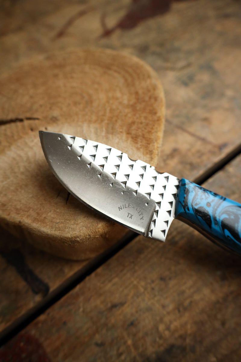 Knife with a blue handle on a wooden surface