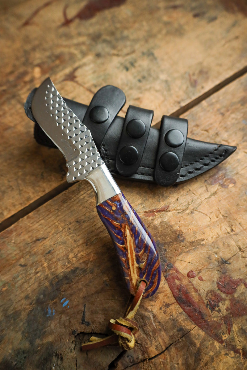 Knife with a decorative handle on a wooden surface