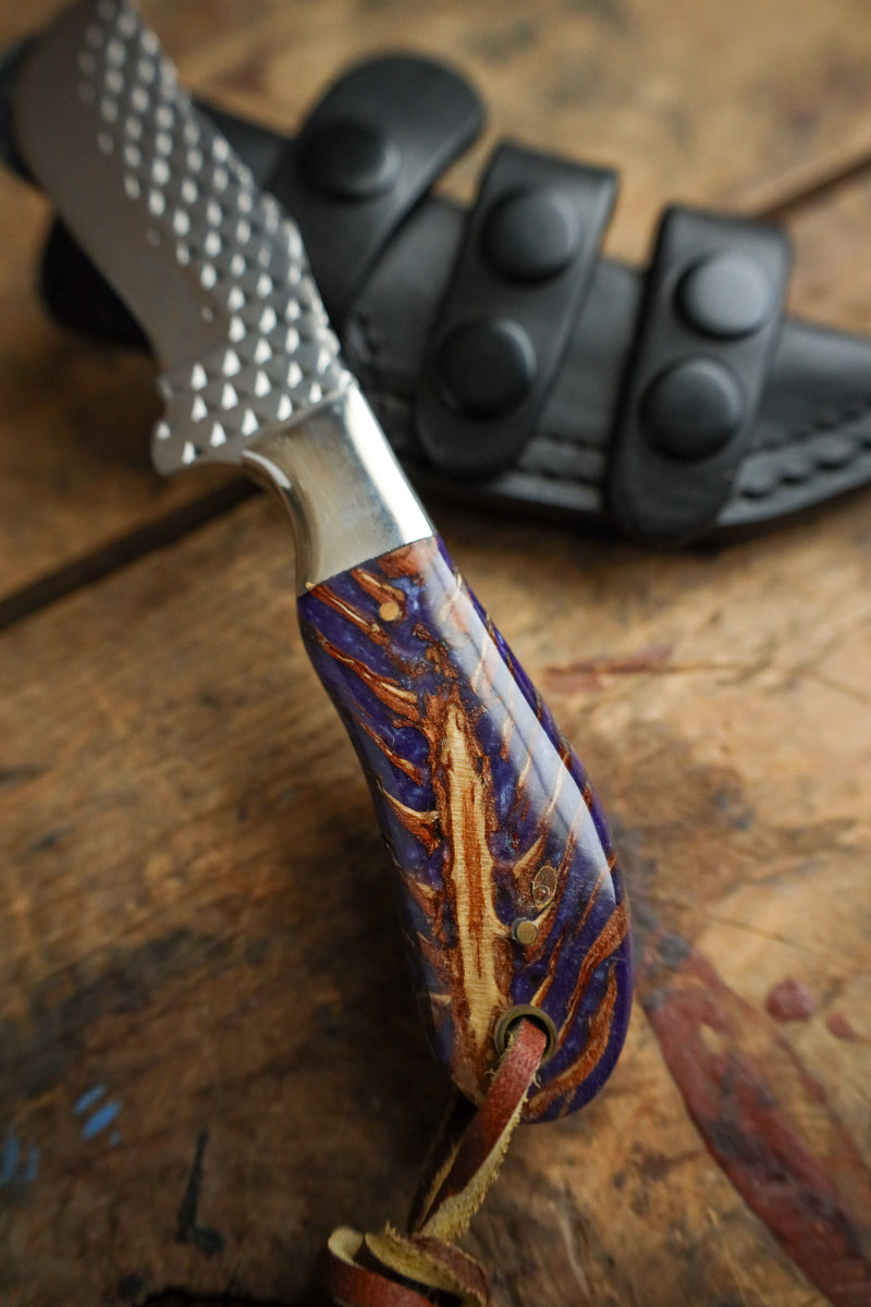 Knife with a decorative handle on a wooden surface