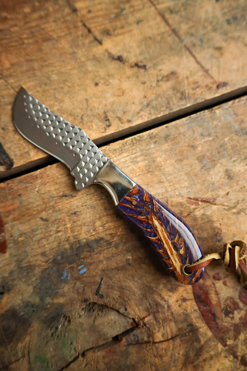 Knife with a decorative handle on a wooden surface