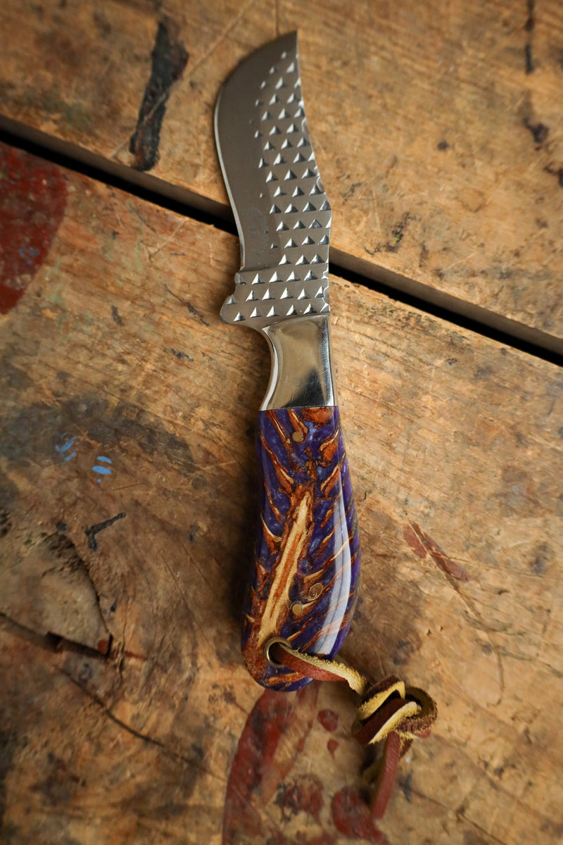 Knife with a decorative handle on a wooden surface