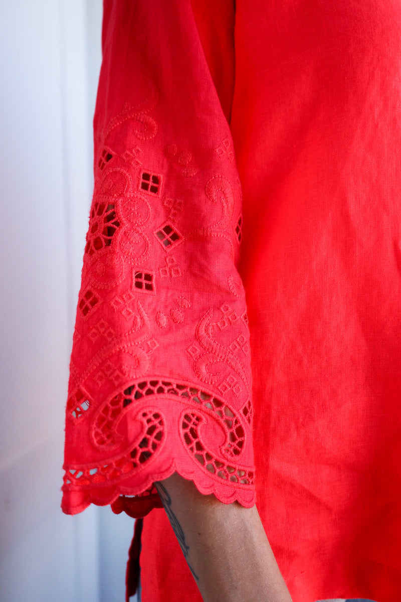 Close-up of a red lace garment with a blurred background