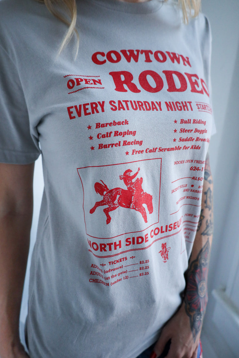 Person wearing a t-shirt with red text and graphics on a white background
