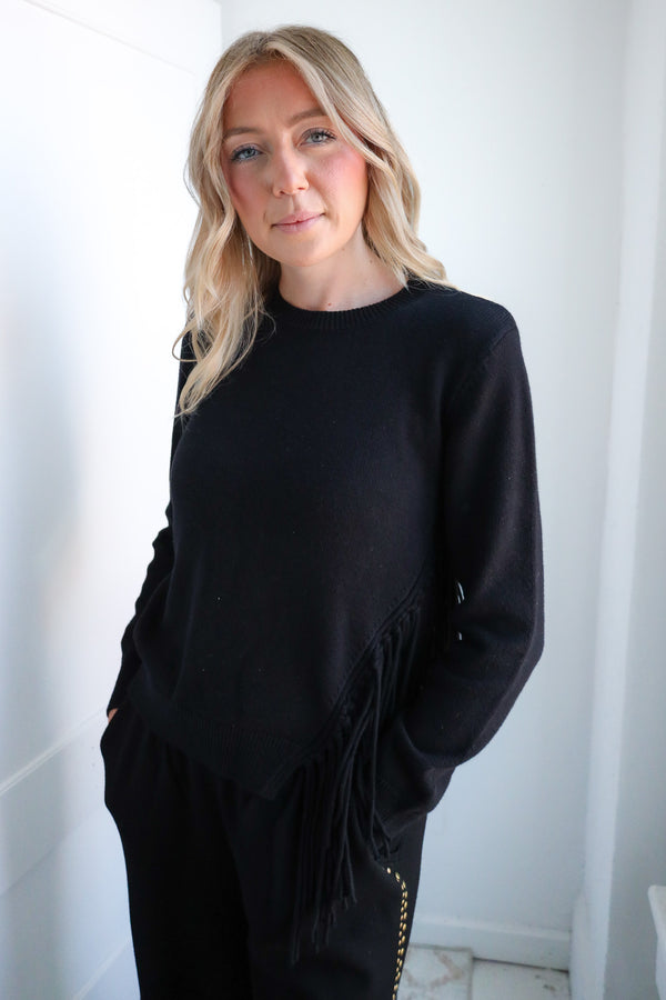 Woman wearing a black outfit against a white background