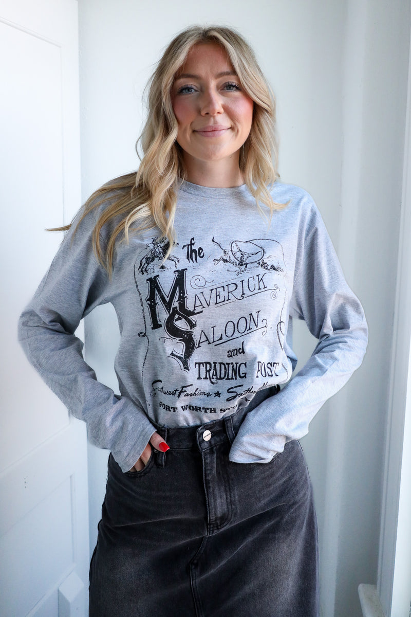 Woman wearing a gray sweatshirt with graphic design against a white background