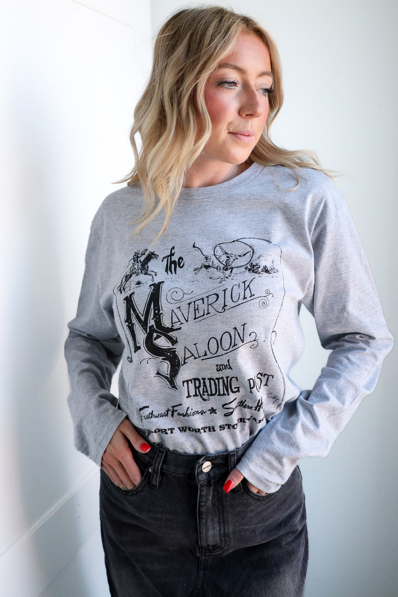 Woman wearing a gray sweatshirt with a graphic design on a white background