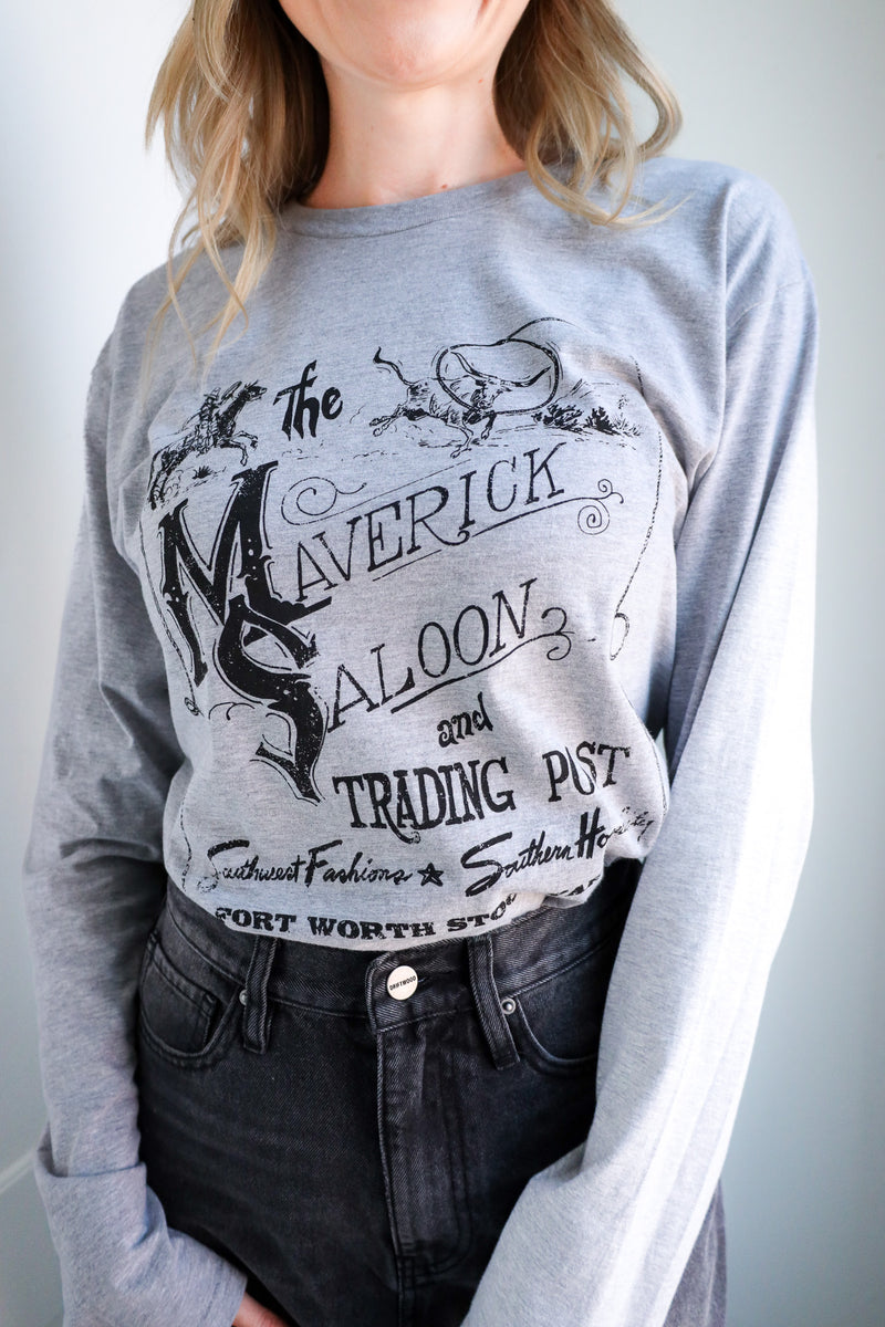 Person wearing a gray sweatshirt with a graphic design on a plain background
