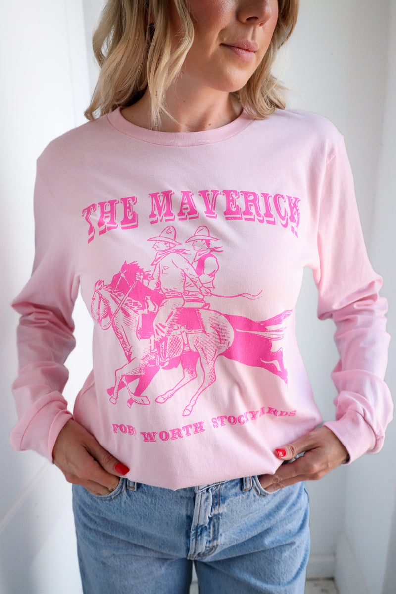 Person wearing a pink long-sleeve shirt with 'The Maverick' graphic design.