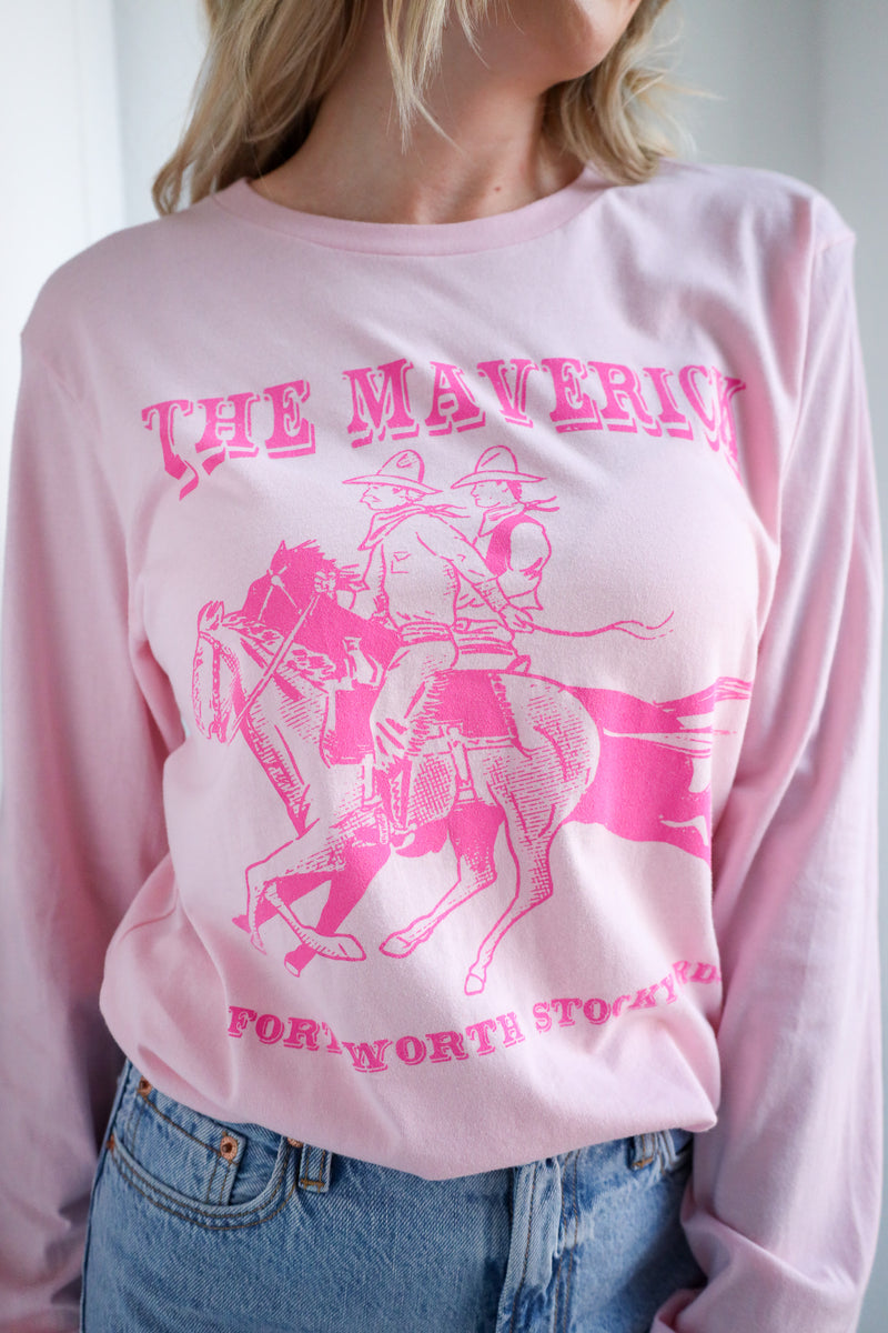Person wearing a pink long-sleeve shirt with 'The Maverick' graphic design.