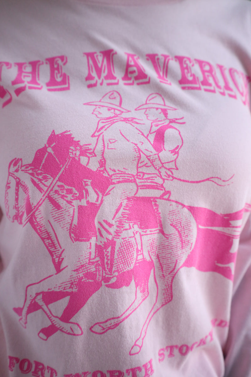 Pink graphic of a cowboy on a horse with 'The Mavericks' text on a white background