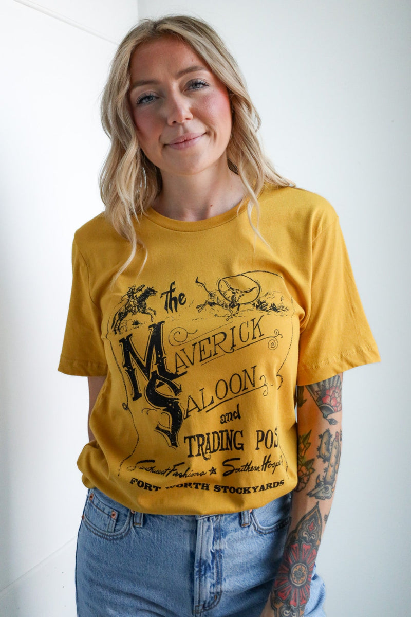Person wearing a yellow t-shirt with graphic design and text, standing against a plain background.