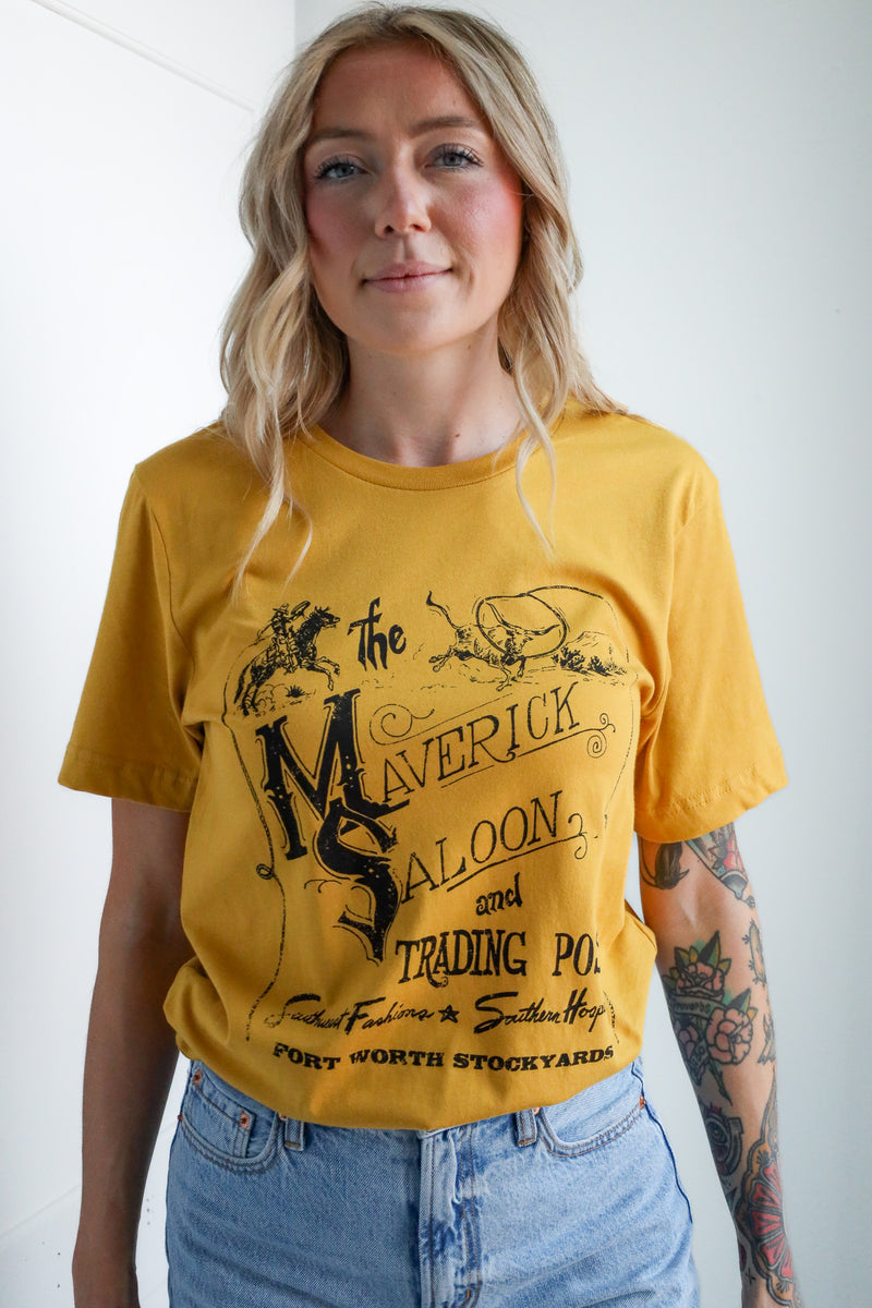 Woman wearing a yellow t-shirt with graphic design and text.