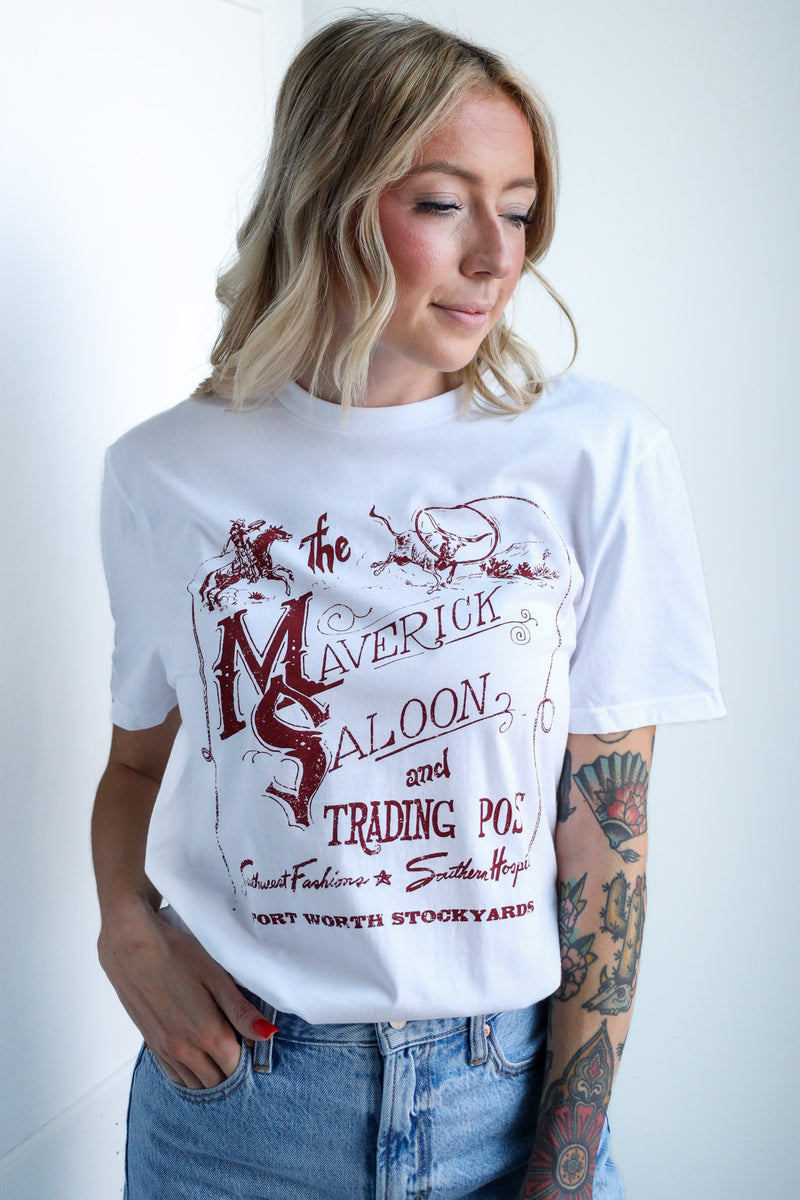 Woman wearing a white t-shirt with red text and graphics on a plain background