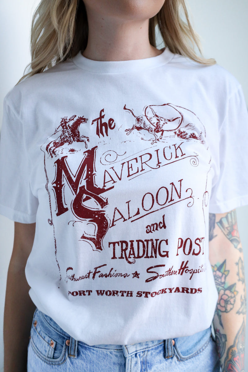 Person wearing a white t-shirt with red graphic design and text.