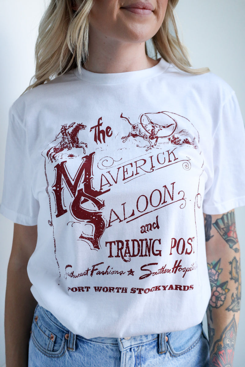 Person wearing a white t-shirt with red graphic design and text.
