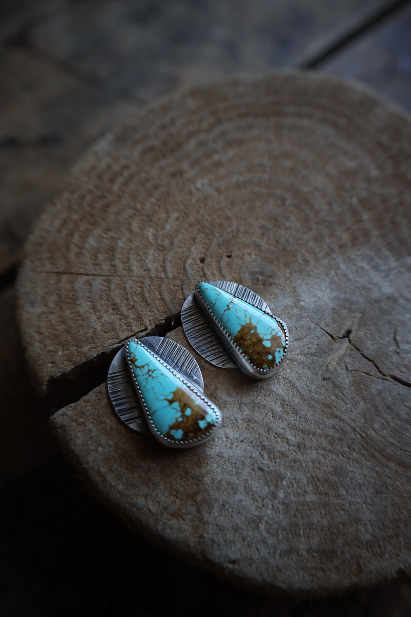 Turquoise and silver hair clip on a wooden surface
