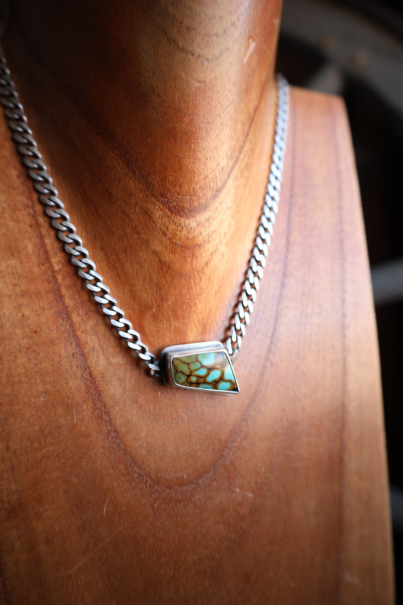 Necklace with a pendant on a wooden surface