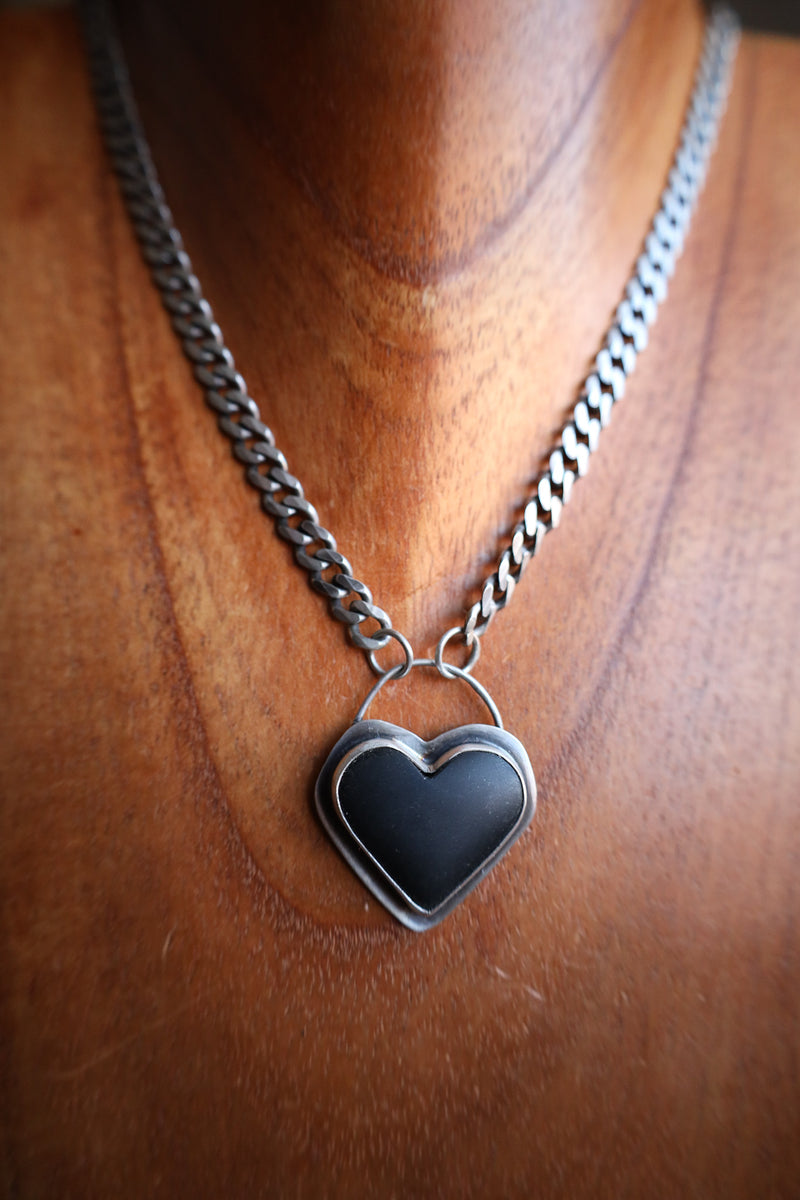 Necklace with a heart-shaped pendant on a wooden surface