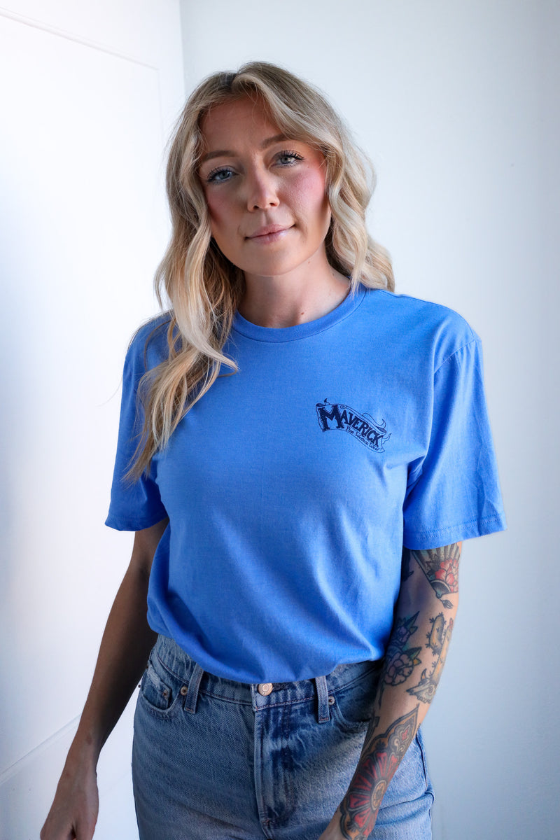 Person wearing a blue t-shirt with a logo against a white background