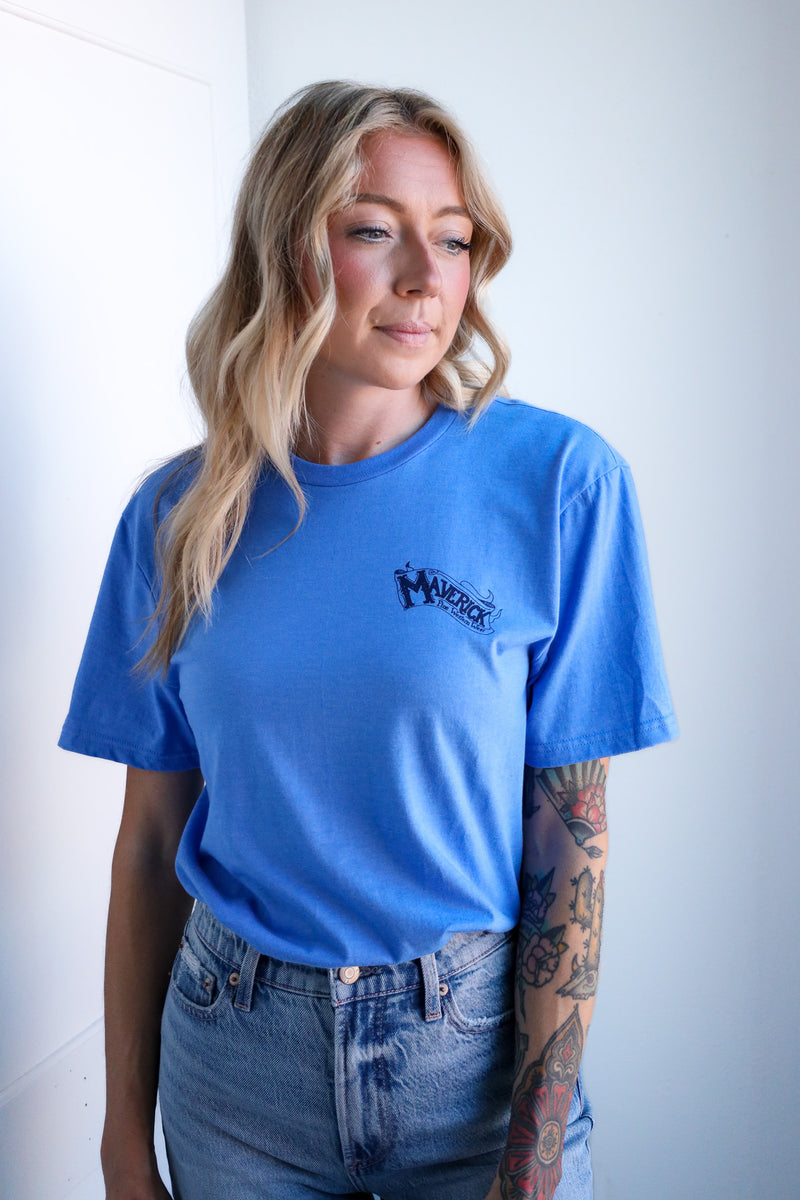 Person wearing a blue t-shirt with a logo against a white background