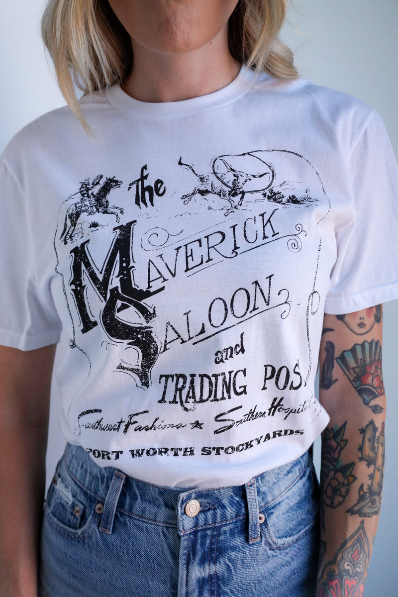 Person wearing a white t-shirt with black text and graphics, paired with blue jeans.