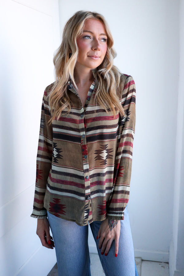 Woman wearing a patterned shirt with a white background