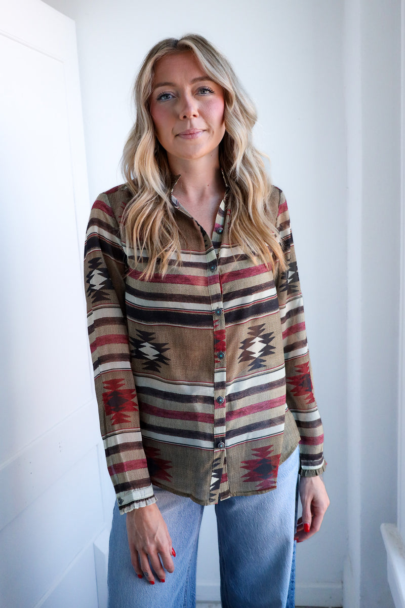Woman wearing a patterned shirt with a white background