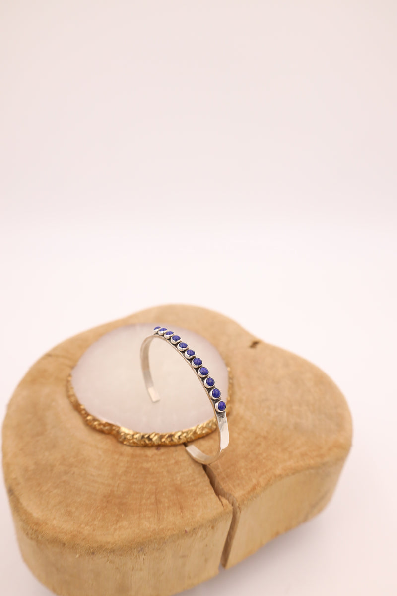 Hammered sterling silver cuff with 11 lapis dots in a line